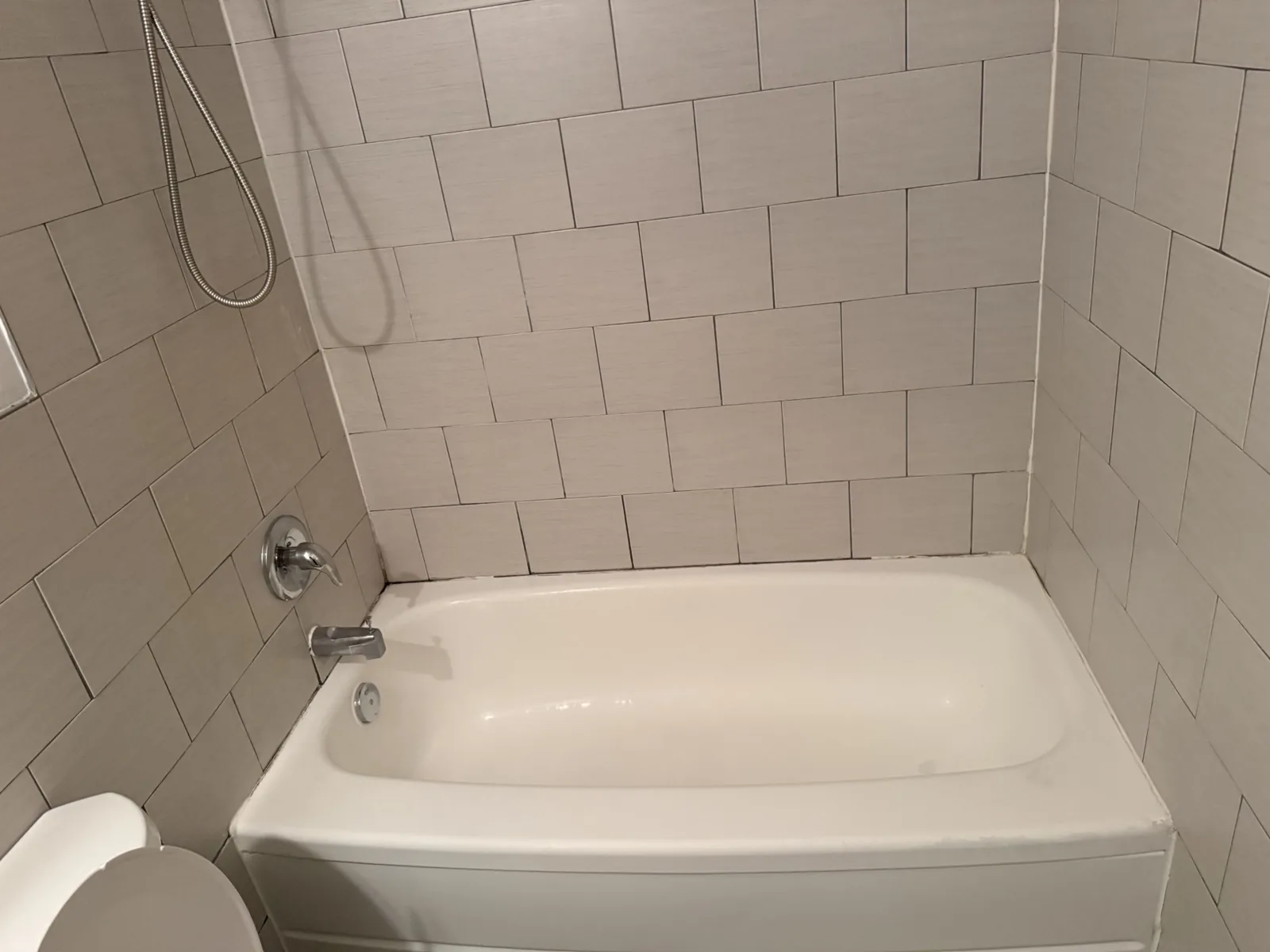 A freshly cleaned bathtub and tiled wall by Balkan Cleaning Services